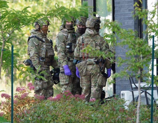 RCMP officers prepare to enter an apartment complex Monday in St-Hubert, Que., in connection with the mailing of ricin to the White House.