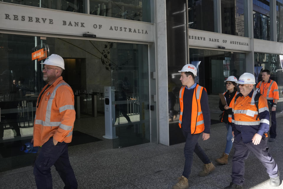 Workers in high visibility clothing walk past the Reserve Bank of Australia in Sydney, Tuesday, Nov. 1, 2022. Australia’s central bank boosted its benchmark interest rate for a seventh consecutive month to a nine-year high of 2.85 percent. (AP Photo/Rick Rycroft)