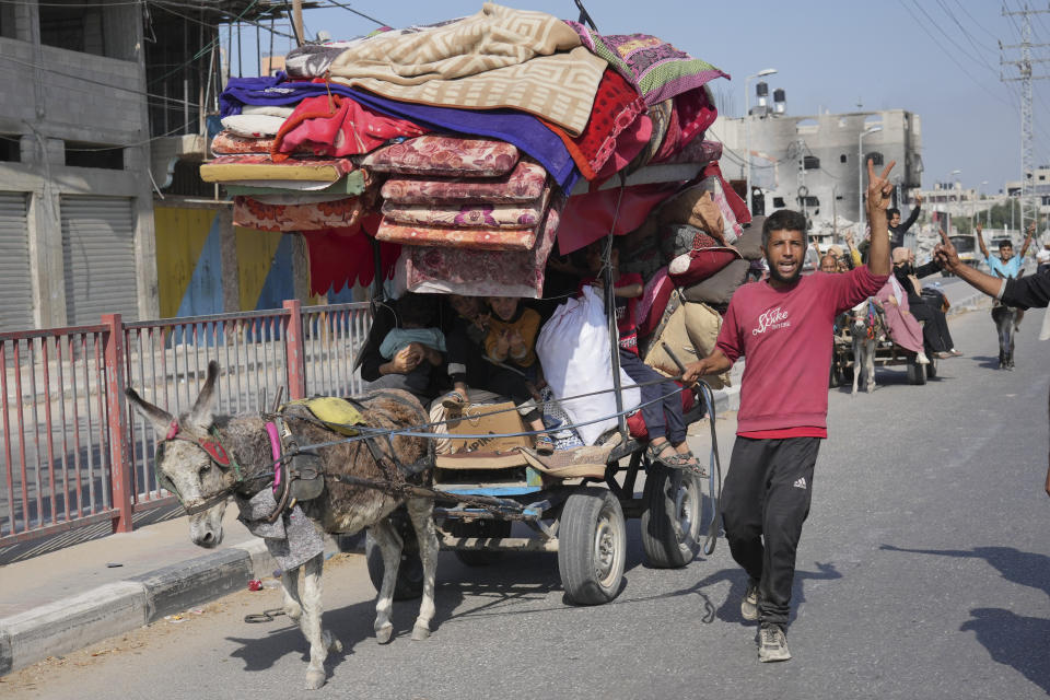 Palestinians flee the southern Gaza Strip on Salah al-Din street in Bureij on Sunday, Nov. 5, 2023. (AP Photo/Hatem Moussa)