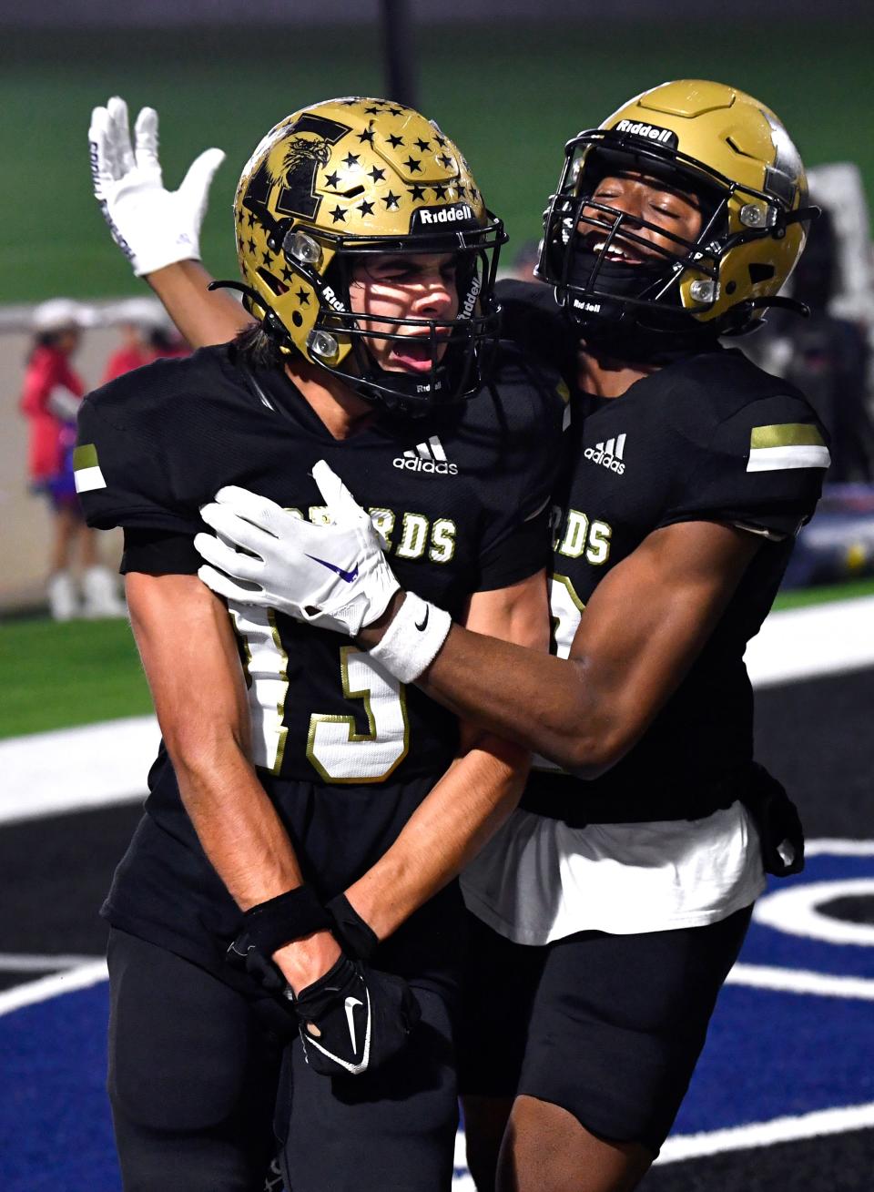 Abilene High wide receiver Jackson Howle is congratulated by teammate Ryland Bradford after Howle’s touchdown against Denton Ryan during Friday’s Class 5A Div. I playoff game in Fort Worth.