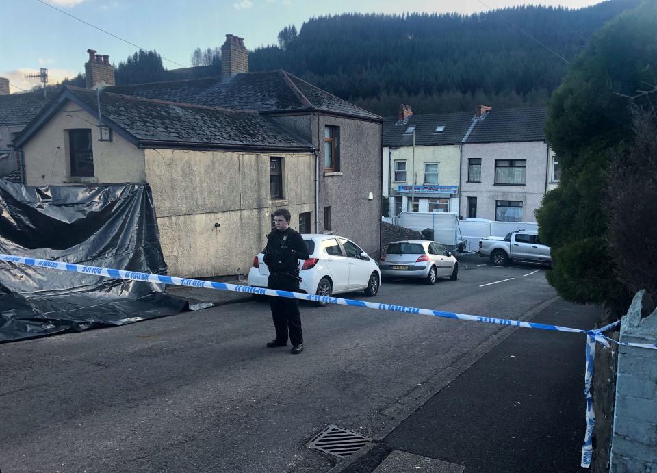 <p>Police at the scene in Treorchy</p> (PA)