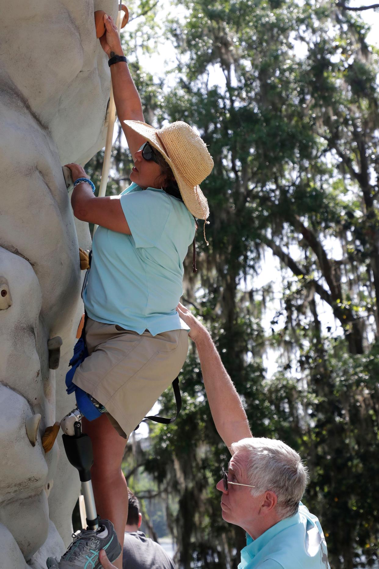 Mariela Mason climbs the rock wall during SportsAbility, a program with the Florida Disabled Outdoors Association, at Maclay Garden State Park Saturday,  April 13, 2019. 