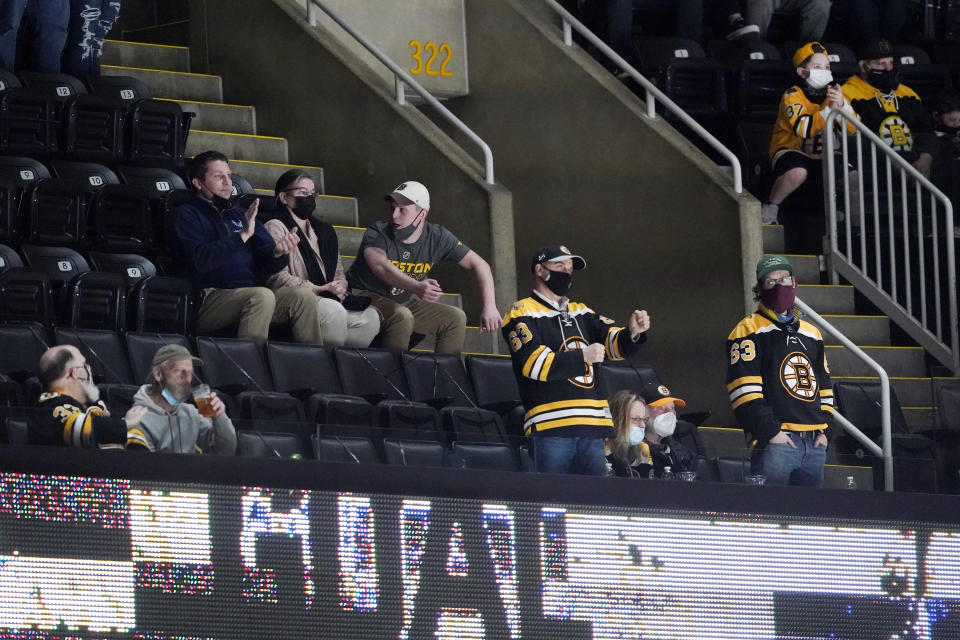 Fans cheer during the second period of an NHL hockey game between the Boston Bruins and the New York Islanders at TD Garden, Monday, May 10, 2021, in Boston, has moved to the next step in its COVID-19 reopening plan, allowing large indoor and outdoor venues, including TD Garden, Fenway Park and Gillette Stadium to increase fan capacity from 12% to 25%. (AP Photo/Elise Amendola)