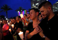 <p>People gather for a candlelight vigil during a memorial service for the victims of the shooting at the Pulse gay nightclub in Orlando on June 13, 2016. (Photo: Jim Young/Reuters) </p>