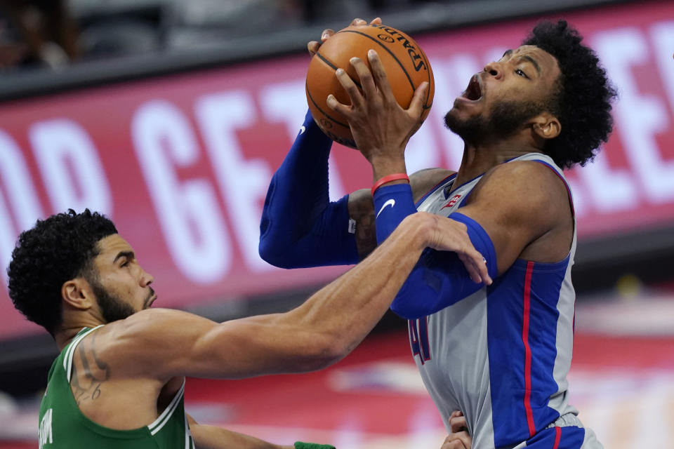 Detroit Pistons guard Saddiq Bey (41) is fouled by Boston Celtics forward Jayson Tatum during the second half of an NBA basketball game Friday, Jan. 1, 2021, in Detroit. (AP Photo/Carlos Osorio)