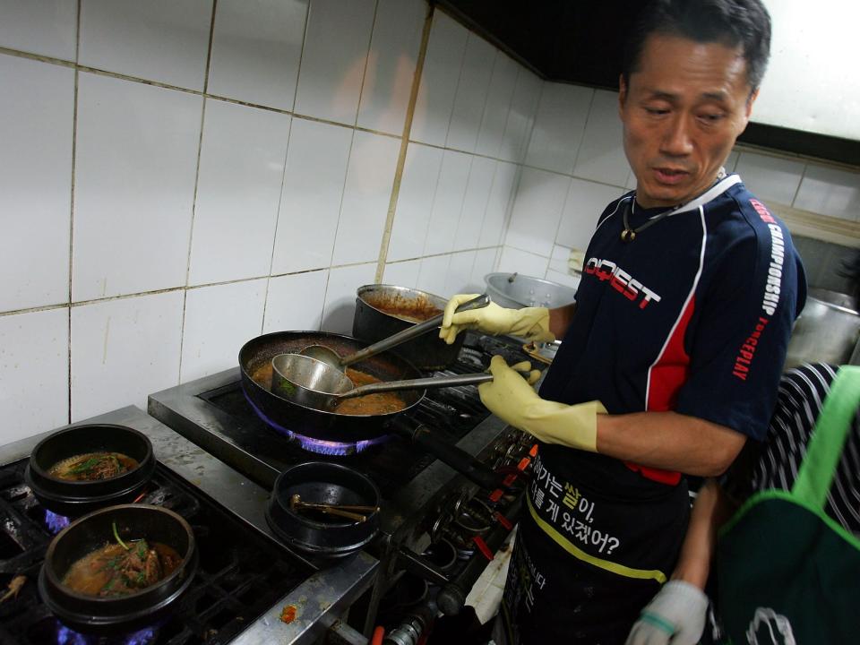 A chef cooks dog meat soup at a restaurant in Seoul, South Korea.