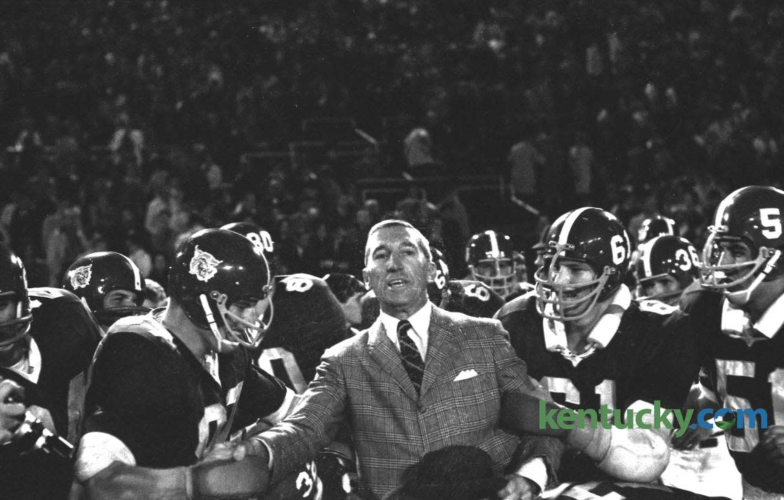 Kentucky football players prepare to put Coach Charlie Bradshaw on their shoulders to carry him off the field after UK defeated Auburn 17-7 at Stoll Field/McLean Stadium in Lexington on Oct. 1, 1966. This was the last time Kentucky defeated Auburn at home.