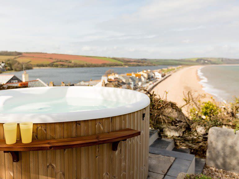 <p><strong>Three nights from £1,729</strong></p><p><a class="link " href="https://go.redirectingat.com?id=127X1599956&url=https%3A%2F%2Fwww.holidaycottages.co.uk%2Fdevon%2Fsouth-devon%2Fcliff-house&sref=https%3A%2F%2Fwww.housebeautiful.com%2Fuk%2Flifestyle%2Fg28446801%2Fromantic-hot-tub-uk-breaks%2F" rel="nofollow noopener" target="_blank" data-ylk="slk:BOOK NOW;elm:context_link;itc:0;sec:content-canvas">BOOK NOW</a> <br></p><p>This luxurious beach rental with spectacular sea views comes with its own private wood-fired hot tub overlooking the family-friendly Slapton Sands – in case you're travelling as a group. When you're not taking in the best of the coast from the bubbly tub, you can dine in Cliff House's grand open-plan kitchen and dining area, which leads out onto a terrace with a bar and BBQ. </p>