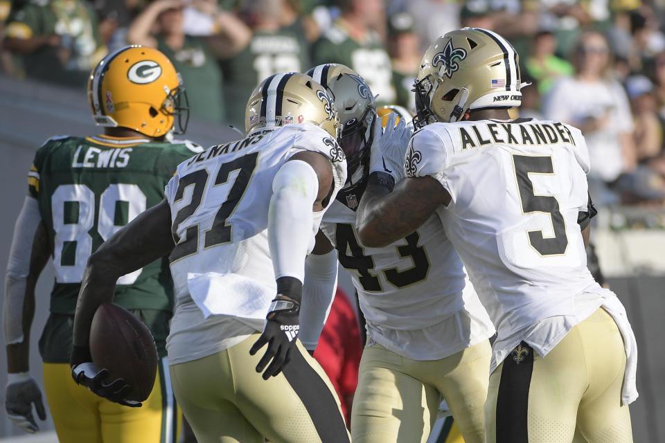 New Orleans Saints middle linebacker Kwon Alexander (5) and strong safety Malcolm Jenkins (27) congratulate free safety Marcus Williams (43) after he intercepted a pass against the Green Bay Packers during the second half of an NFL football game, Sunday, Sept. 12, 2021, in Jacksonville, Fla. (AP Photo/Phelan M. Ebenhack)