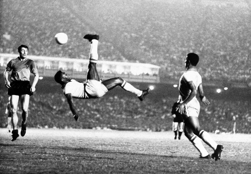 FILE - In this Sept. 1968 file photo, Brazil's Pele kicks the ball during a friendly soccer game against Belgium in Rio de Janeiro, Brazil. On Oct. 23, 2020, the three-time World Cup winner Pelé turns 80 without a proper celebration amid the COVID-19 pandemic as he quarantines in his mansion in the beachfront city of Guarujá, where he has lived since the start of the pandemic. (AP Photo, File)