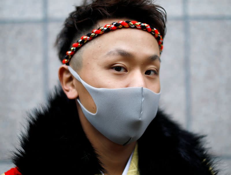 Kimono-clad man wearing a face mask poses for a photograph at Coming of Age Day celebration ceremony amid the coronavirus disease (COVID-19) outbreak, in Yokohama, Japan