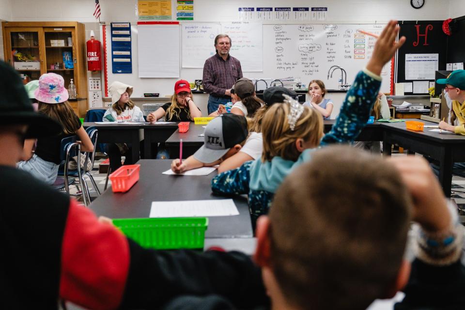 Times-Reporter staff writer Jon Baker takes questions from students learning to create a newspaper during an after-school program run by teachers Jamie Horger and Sarah Witting at Tuscarawas Valley Intermediate School.