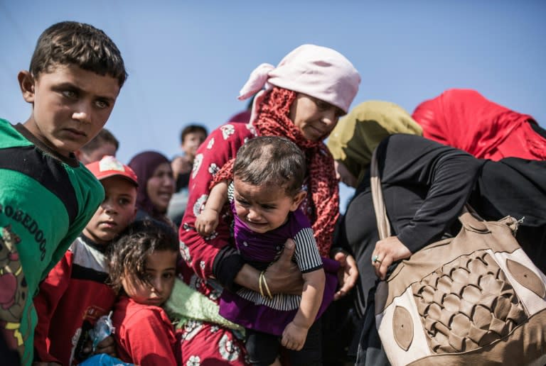 Syrian refugees who had fled Tal Abyad re-enter the country from Turkey on June 22, 2015, after Kurdish People's Protection Units took control of the area