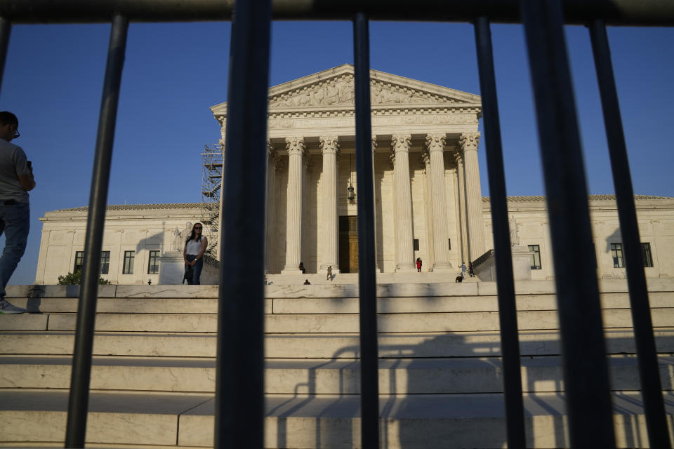 The Supreme Court building behind a fence.