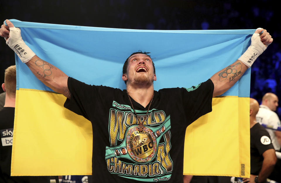 Oleksandr Usyk celebrates after victory against Tony Bellew in their cruiserweight boxing bout Saturday, Nov. 10, 2018, in Manchester, England. Usyk successfully defended his four belts and likely sent Bellew into retirement by knocking out the British fighter in the eighth round. (Nick Potts/PA via AP)