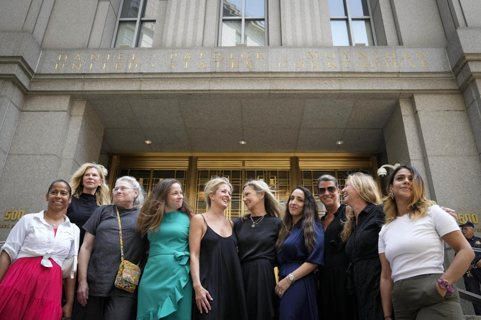 Sexual assault victims share smiles as they gather for a group photograph after sentencing proceedings concluded for convicted sex offender Robert Hadden outside Federal Court, Tuesday, July 25, 2023, in New York. (AP Photo/John Minchillo)