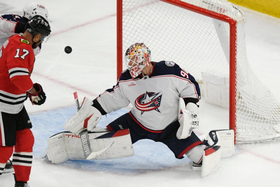 Columbus Blue Jackets goalie Elvis Merzlikins (90) makes a save during the second period of an NHL hockey game against the Chicago Blackhawks, Saturday, March 2, 2024, in Chicago. (AP Photo/Paul Beaty)