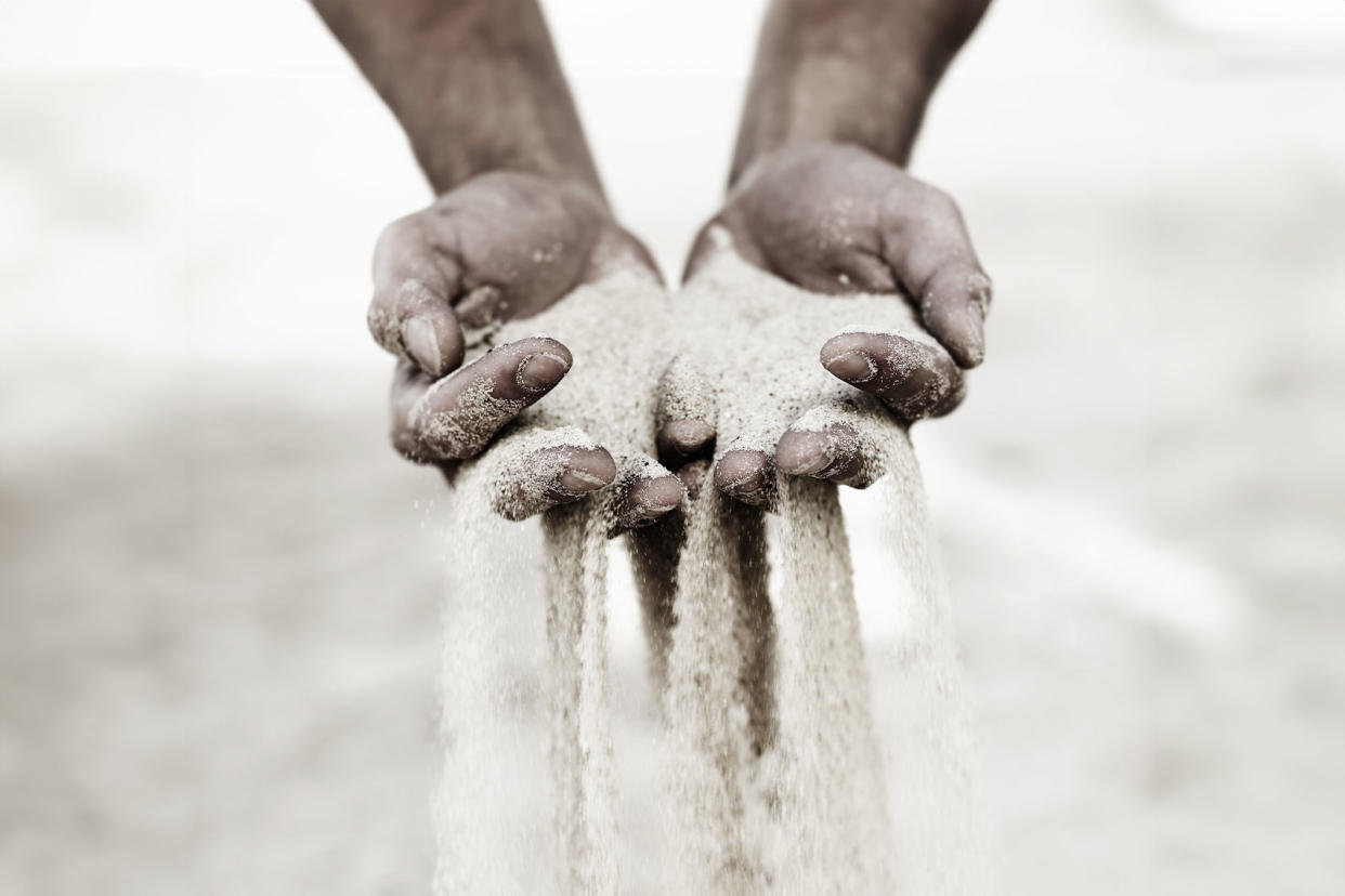 Sand slipping through fingers Getty Images/PeopleImages
