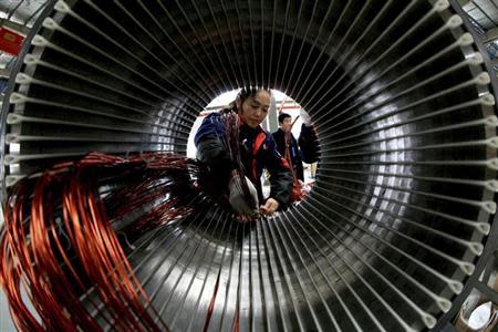 A worker assembles a generator at a factory in Hefei, Anhui province November 2, 2013. REUTERS/China Daily