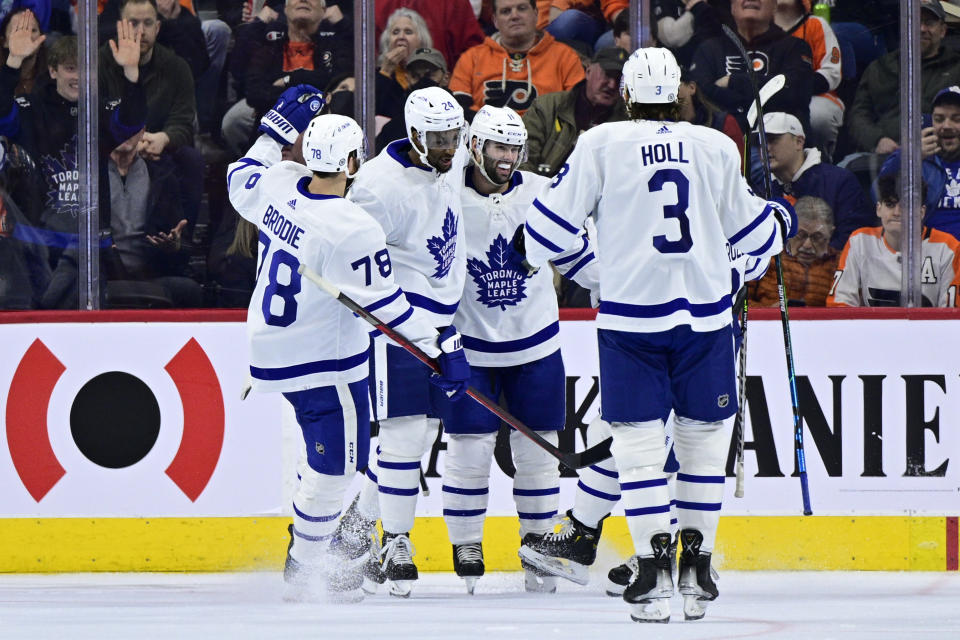 Toronto Maple Leafs' Wayne Simmonds, second from left, celebrates his goal with Colin Blackwell (11), Justin Holl (3), TJ Brodie (78) and Nicholas Abruzzese, obscured, during the second period of the team's NHL hockey game against the Philadelphia Flyers, Saturday, April 2, 2022, in Philadelphia. (AP Photo/Derik Hamilton)