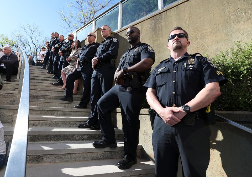 Louisville Metro Police officers attend a community vigil at the Ali Center to honor the victims of the mass shooting at the Old National Bank that occurred earlier in the week in Louisville, Ky. on Apr. 12, 2023.  