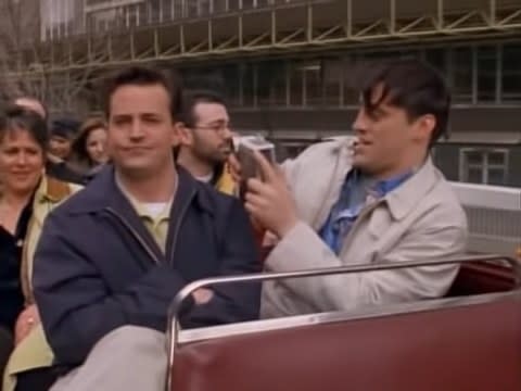 Joey filming Chandler on a red bus in London in "Friends"
