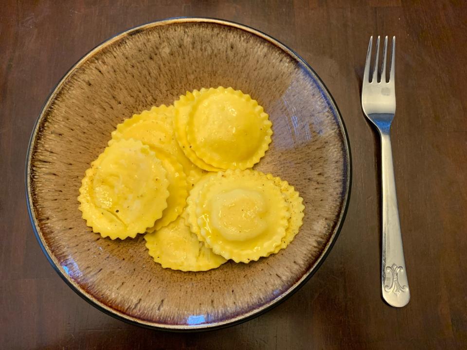 brown plate with trader joe's lemon ricotta ravioli and fork