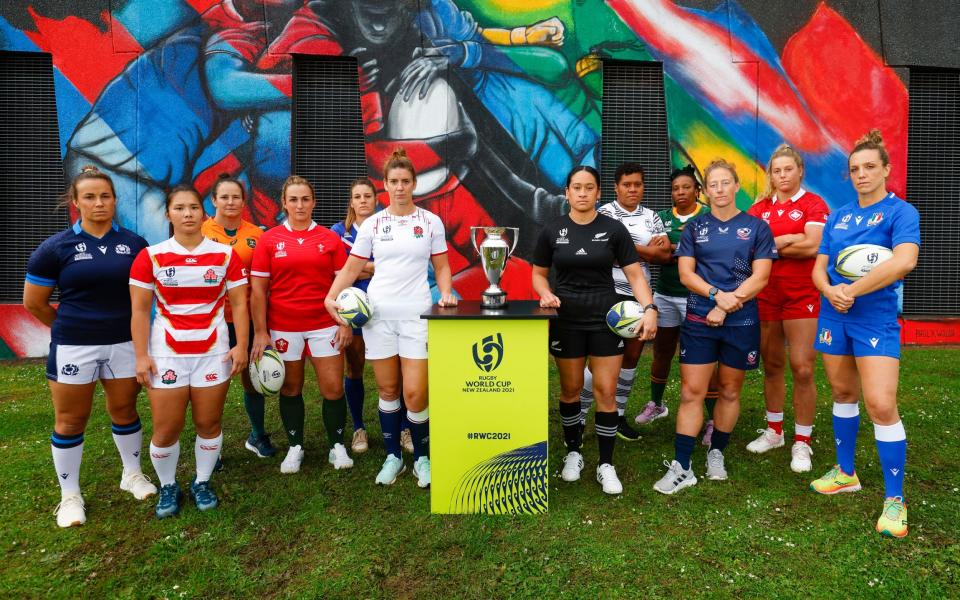 The captains of all 12 teams line up next to the trophy they hope they'll be lifting in a month's time - GETTY IMAGES