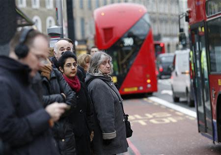 Commuters wait to board buses during London Underground strikes at Kings Cross underground station in London February 6, 2014. REUTERS/Olivia Harris