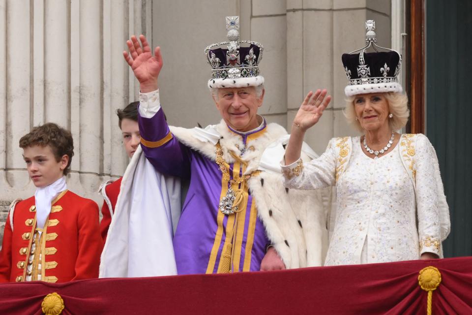 King Charles and Queen Camilla waved to people while standing on the Buckingham Palace balcony. (Photo by DANIEL LEAL/AFP via Getty Images)
