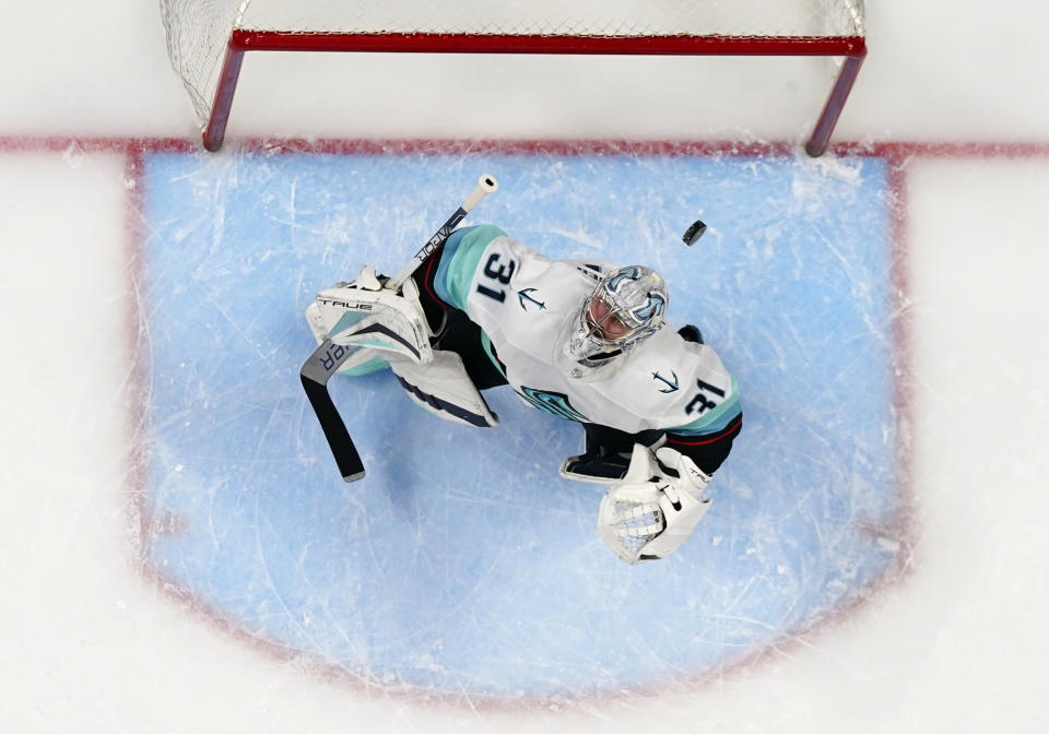 Seattle Kraken goaltender Philipp Grubauer (31) eyes the puck as it flies over his head during the first period in Game 1 of the team's first-round NHL hockey playoff series against the Colorado Avalanche on Tuesday, April 18, 2023, in Denver (AP Photo/Jack Dempsey)