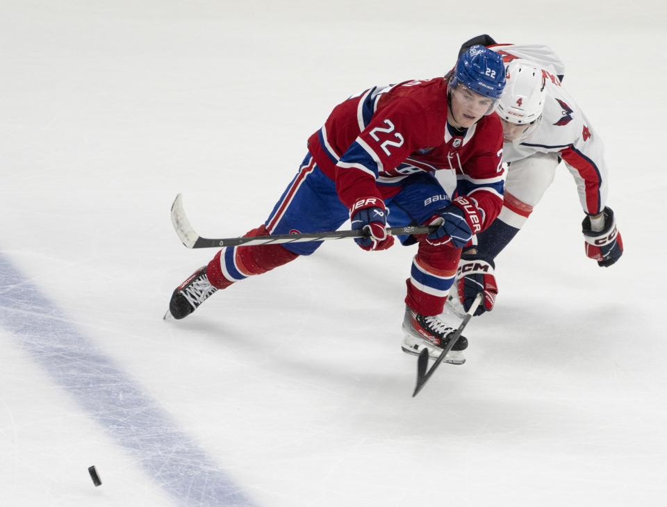 Montreal Canadiens' Cole Caufield (22) battles for the puck against Washington Capitals' Hardy Haman Aktell (4) during the second period of an NHL hockey game in Montreal on Saturday, Oct. 21, 2023. (Christinne Muschi/The Canadian Press via AP)