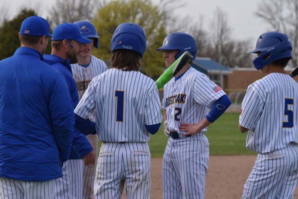 Ida coach Jimmy McMonagle has an offensive conference with his team Friday. The Blue Streaks fought back from a 10-0 deficit before falling to St. Mary Catholic Central 10-9.