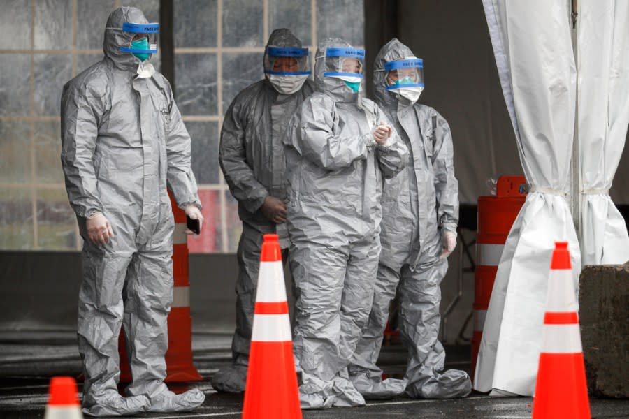 FILE – Medical personnel await patients for COVID-19 coronavirus testing facility at Glen Island Park, Friday, March 13, 2020, in New Rochelle, N.Y. Some states that stockpiled millions of masks and other personal protective equipment during the coronavirus pandemic are now throwing the items away. (AP Photo/John Minchillo, File)
