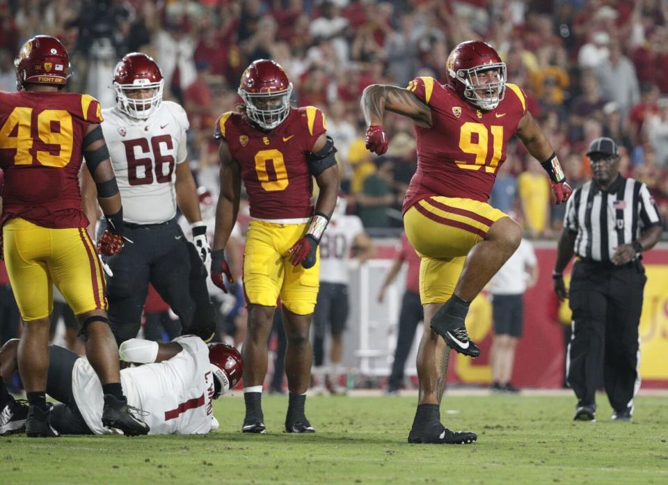 USC defensive lineman Brandon Pili reacts after sacking Washington State quarterback Cameron Ward