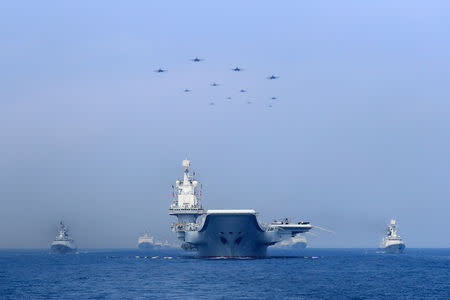 FILE PHOTO: Warships and fighter jets of Chinese People's Liberation Army (PLA) Navy take part in a military display in the South China Sea April 12, 2018. REUTERS/Stringer