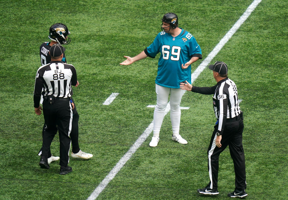 Daniel Jarvis, known as Jarvo 69, in confronted by Jacksonville Jaguars' Logan Cooke as he invades the pitch during the match between the Jacksoville Jaguars and Miami Dolphins at Tottenham Hotspur Stadium, London.