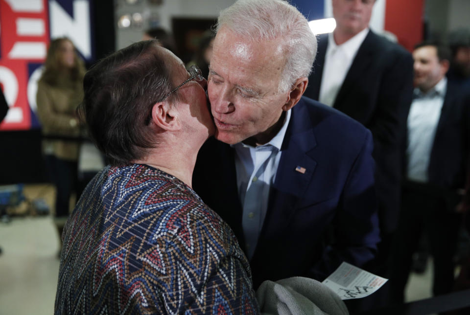 Democratic presidential candidate former Vice President Joe Biden kisses Penny Cordes during a campaign event on foreign policy at a VFW post Wednesday, Jan. 22, 2020, in Osage, Iowa. (AP Photo/John Locher)