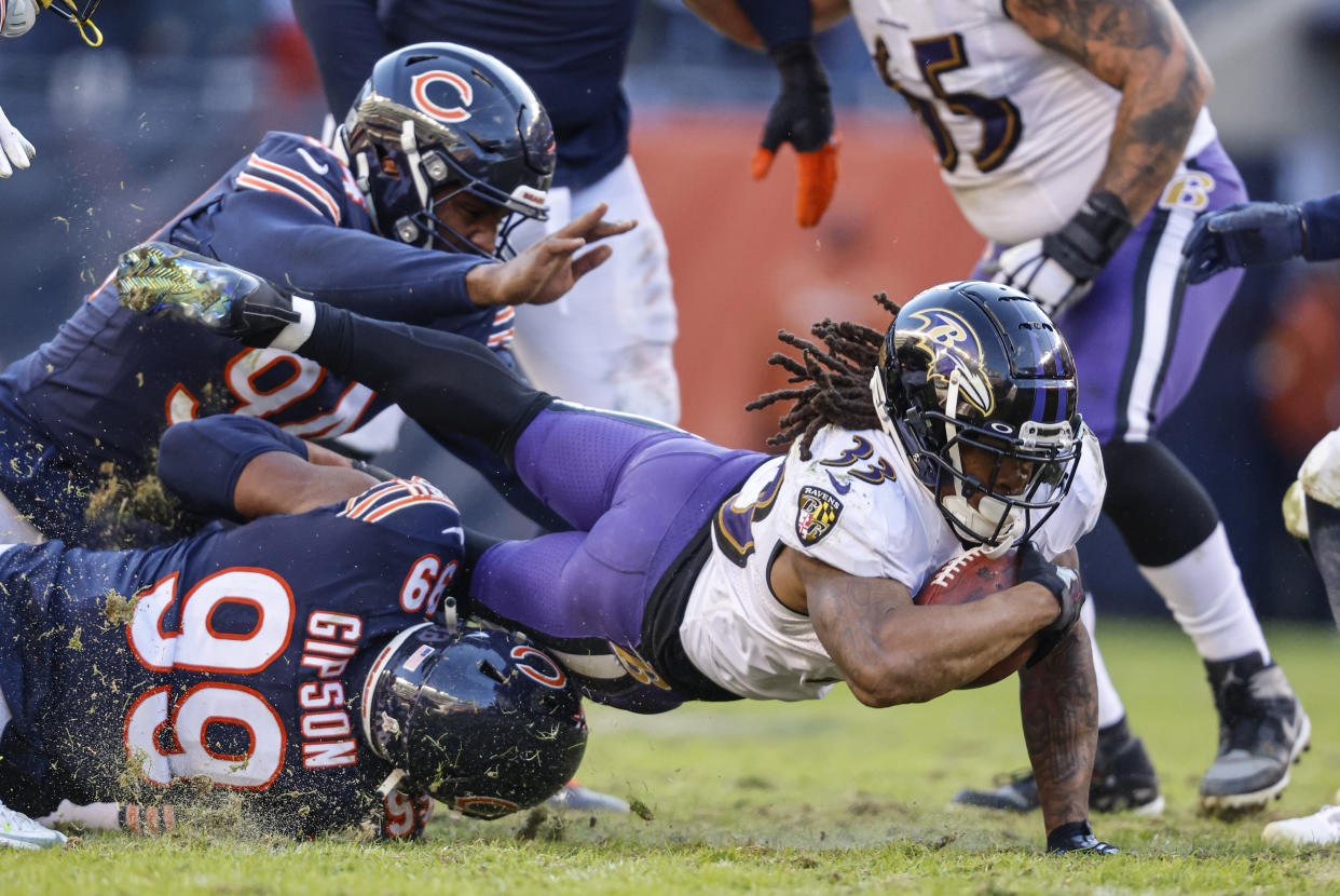 Baltimore Ravins' Devonta Freeman(33) dives for yardage against the Chicago Bears during an NFL football game Sunday, Nov 21. 2021, in Chicago. (AP Photo/Jeffrey Phelps)