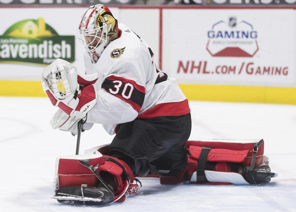 Ottawa Senators goalie Matt Murray makes a glove-save during the second period of an NHL hockey game in Vancouver, British Columbia, Thursday, April 22, 2021. (Darryl Dyck/The Canadian Press via AP)