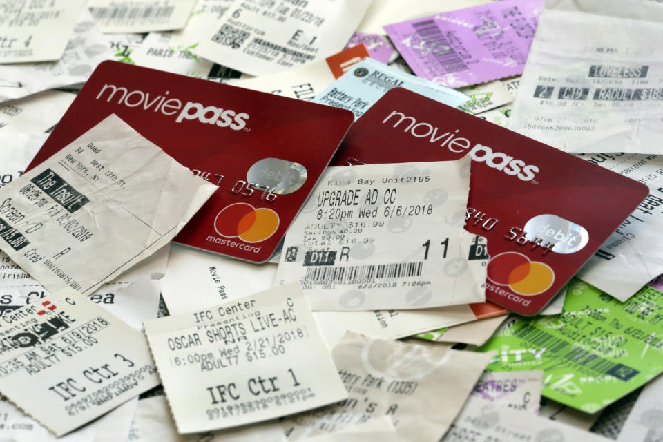 FILE - This Aug. 23, 2018, file photo shows Movie Pass debit cards and used movie tickets in New York. Sinemia says it's discontinuing operations in the U.S., just months after it started a movie-a-day plan to fill a void left by last summer's fall of MoviePass. Both services were financially unsustainable as they paid theaters full prices for tickets, while charging customers as little as $10 a month. (AP Photo/Richard Drew, File)