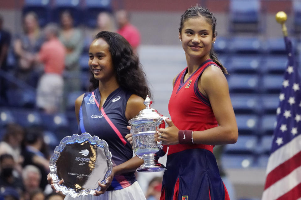 Emma Raducanu, of Britain, right, poses for photos with Leylah Fernandez, of Canada, after defeating Fernandez in the women's singles final of the US Open tennis championships, Saturday, Sept. 11, 2021, in New York. (AP Photo/Elise Amendola)