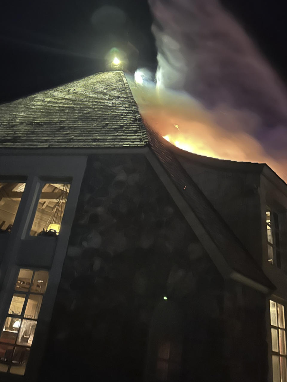 Firefighters extinguish a fire at Oregon's historic Timberline Lodge, which was featured in Stanley Kubrick's 1980 film "The Shining," Thursday evening, April 18, 2024, in Government Camp, Ore. (Clackamas Fire Department via AP)