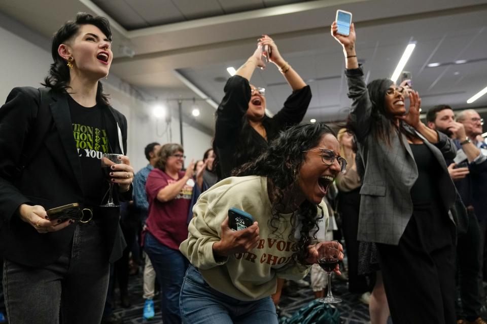 Mason Hickman, left, and Shakti Rambarran, front, of the Ohio Women’s Alliance react during a gathering for supporters of Issue 1 at the Hyatt Regency Downtown. The issue establishes a constitutional right to abortion.