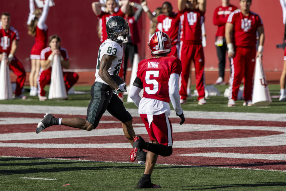 Michigan State wide receiver Montorie Foster Jr. (83) looks back to the nearest defender, Indiana defensive back Kobee Minor (5), as he crosses into the end zone to score during an NCAA college football game, Saturday, Nov. 18, 2023, in Bloomington, Ind. (AP Photo/Doug McSchooler)