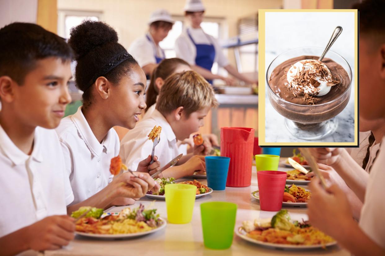  School children eating school lunch as main and drop in of chocolate mousse 