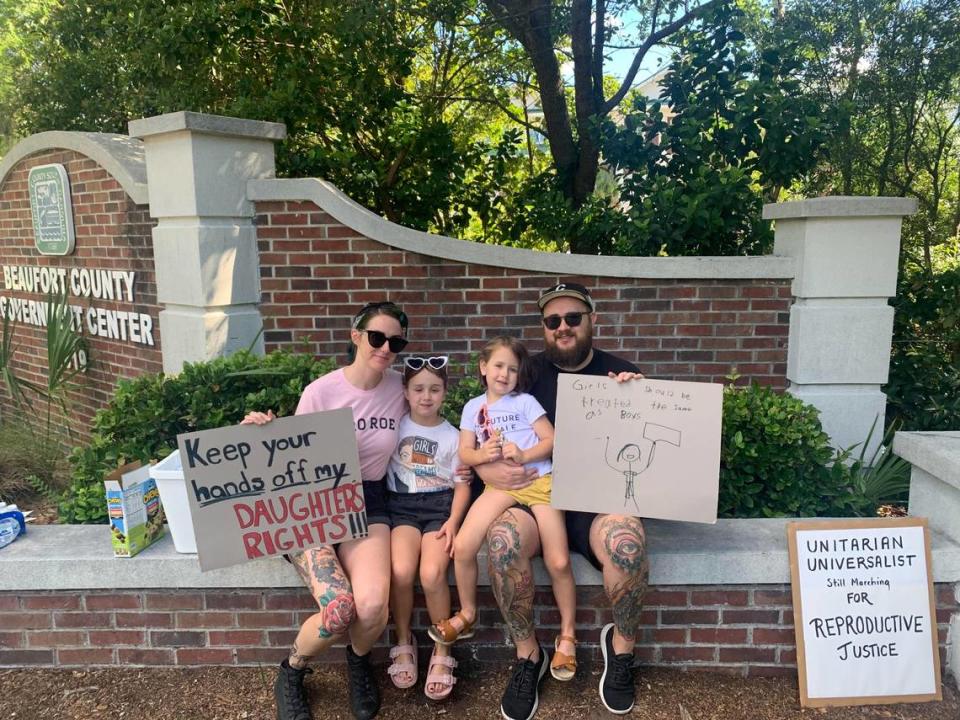 Carrie and Will Strong came to the protest with their two daughters, Olive and Ellie.