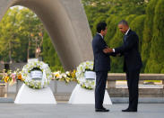 <p>President Barack Obama (R) puts his arm around Japanese Prime Minister Shinzo Abe after they laid wreaths in front of a cenotaph at Hiroshima Peace Memorial Park in Hiroshima, Japan May 27, 2016. (Photo: Carlos Barria/Reuters) </p>