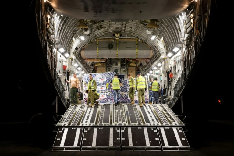 A handout photo shows Royal Australian Air Force personnel preparing to unload Australian Aid supplies from a C-17 Globemaster on the runway at Luganville's Santo-Pekoa International Airport in Vanuatu as part of Operation Vanuatu Assist 2017