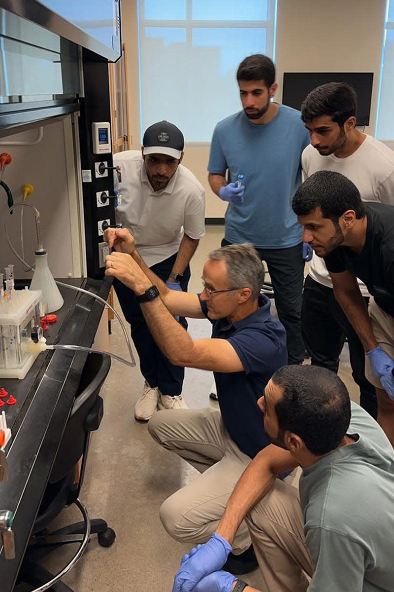 Dubai Police Force students work with Forensic Science program chair Frank Bailey, professor of biology, to examine a sample in a forensic lab as part of the Business Analytics and Forensic Science Global Study program in August at Middle Tennessee State University.